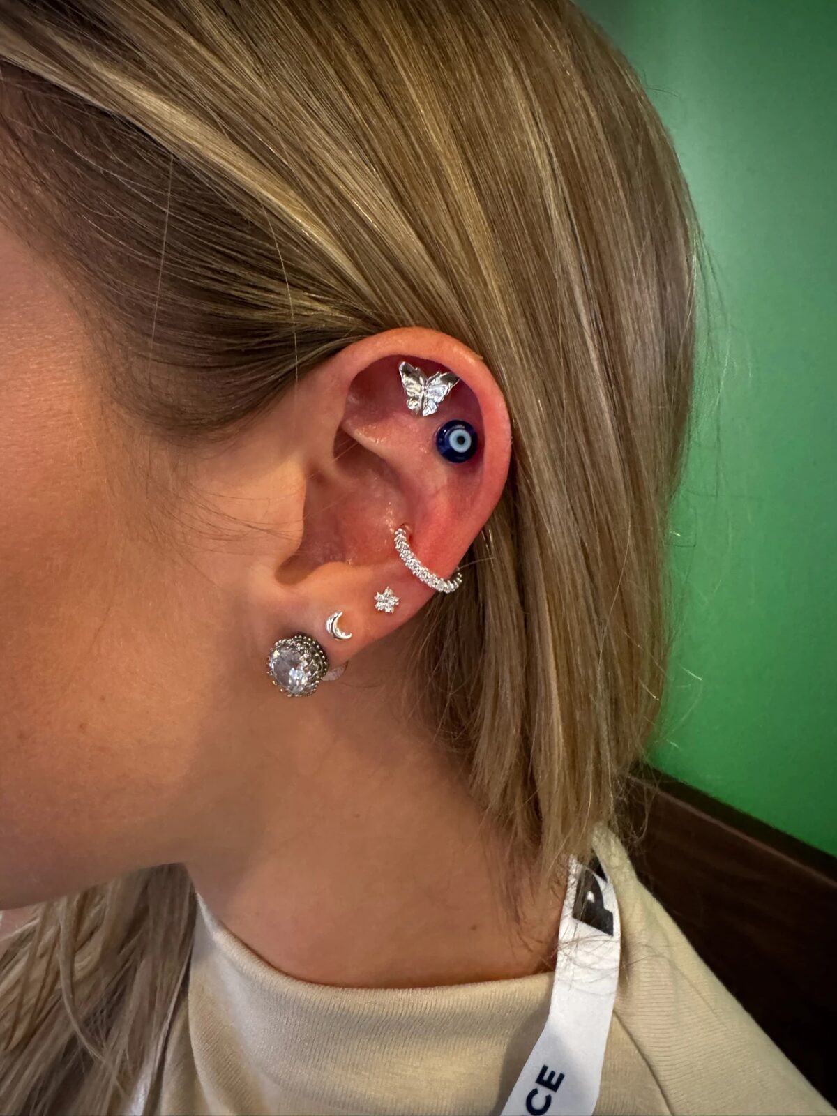 Silver butterfly and evil-eye Revelmarks ear stack at CommerceNext