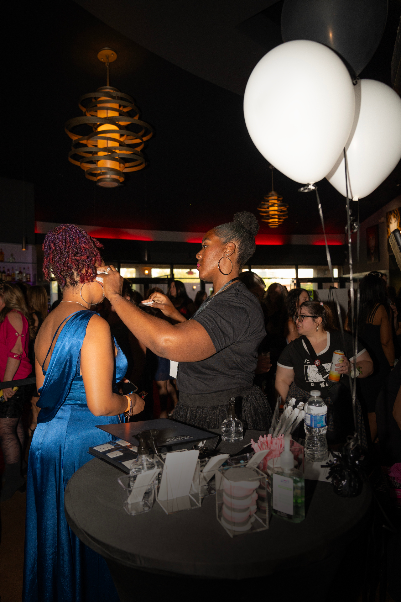 Revel Road artist styling a guest at a live brand activation
