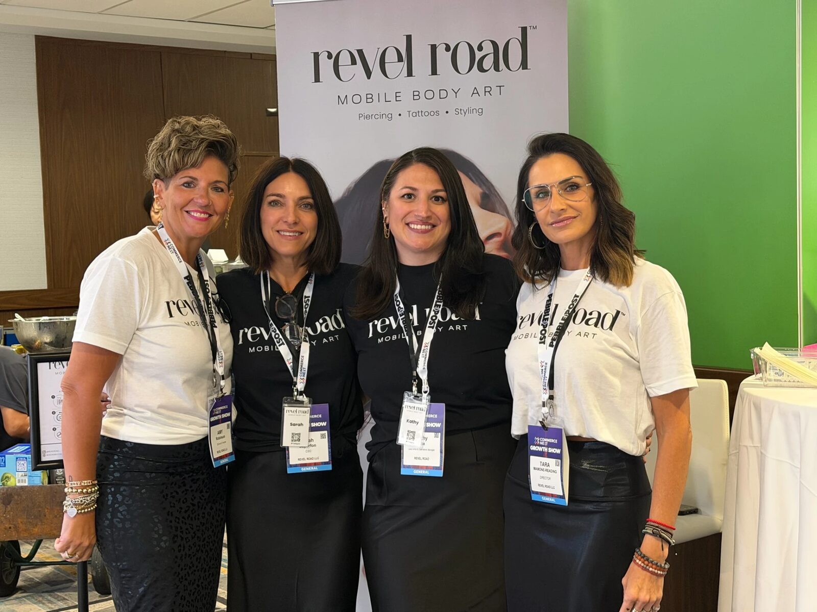 The Revel Road team in front of a Revel Road banner at the CommerceNext Growth Show