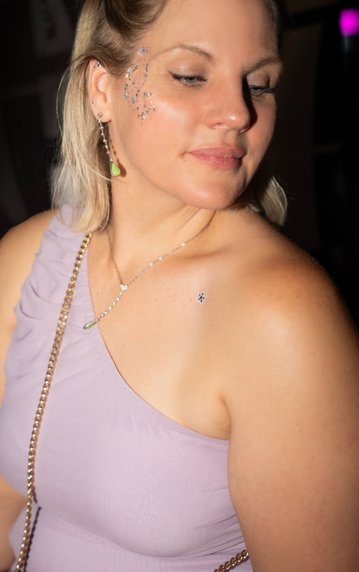 Guest with layered glitter face styling and crystal accents