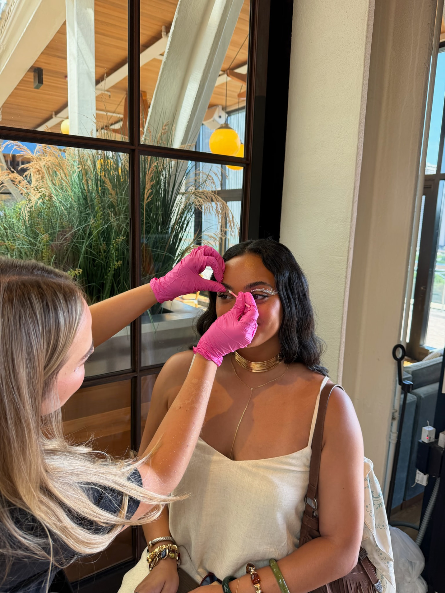 Artist applying face gems to a guest at a brand activation