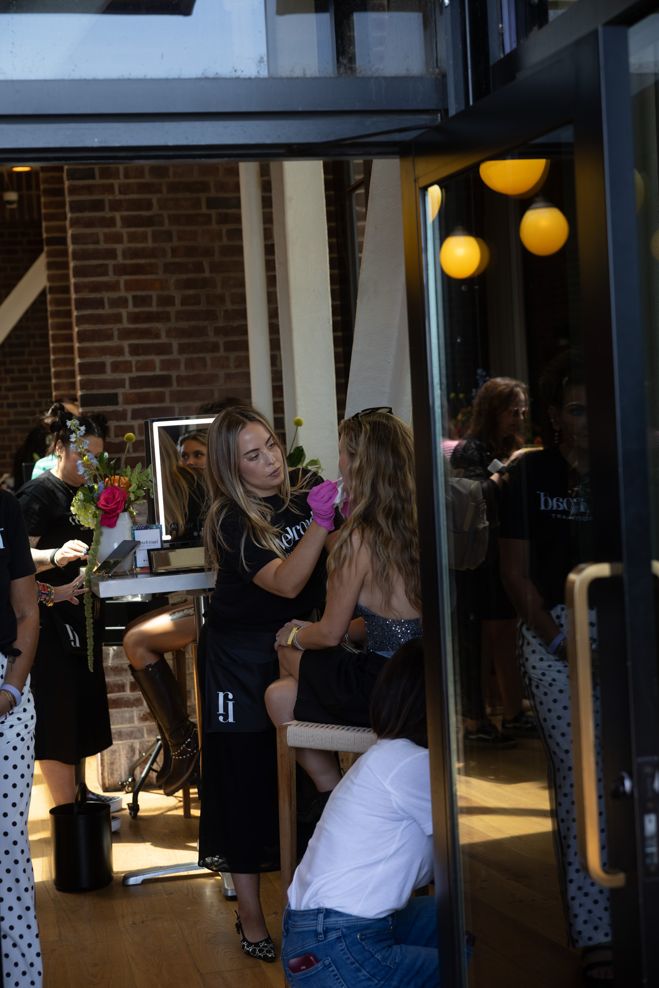 Revel Road artist styling a guest at a brand activation